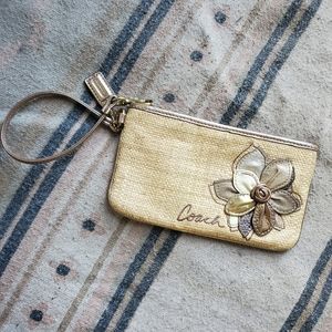 Coach straw wristlet with leather flower